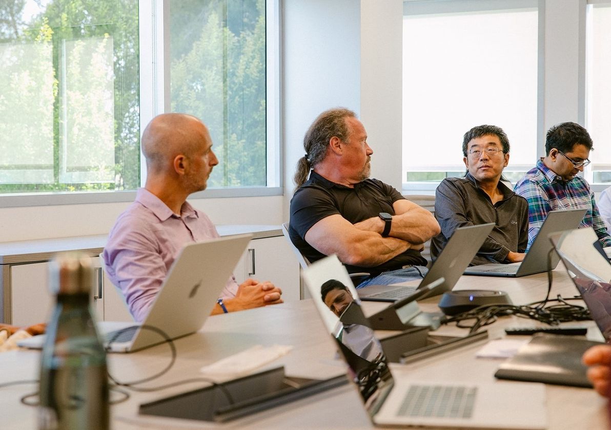 Engineers at laptops during a working session