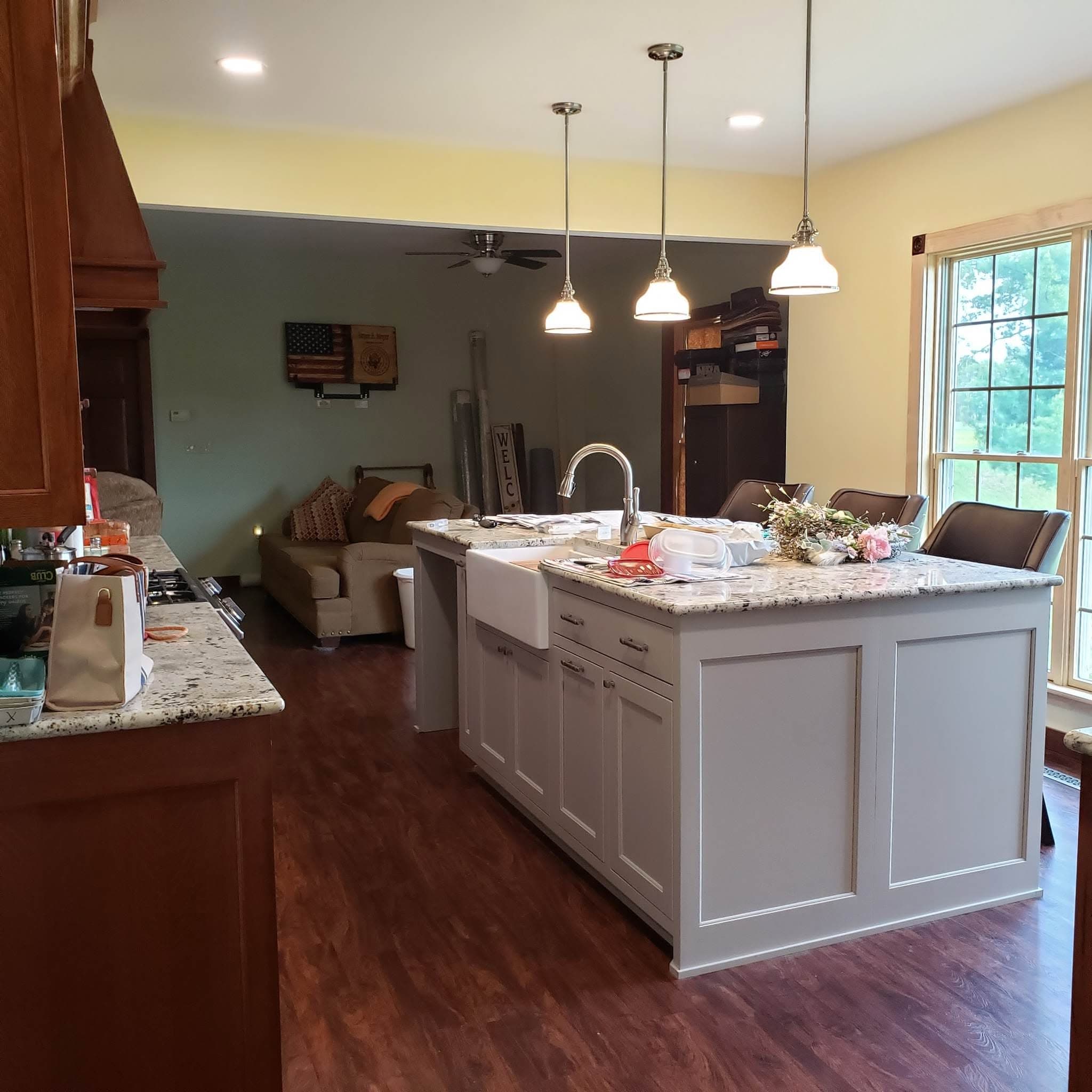 Open-concept kitchen island with custom wood range hood