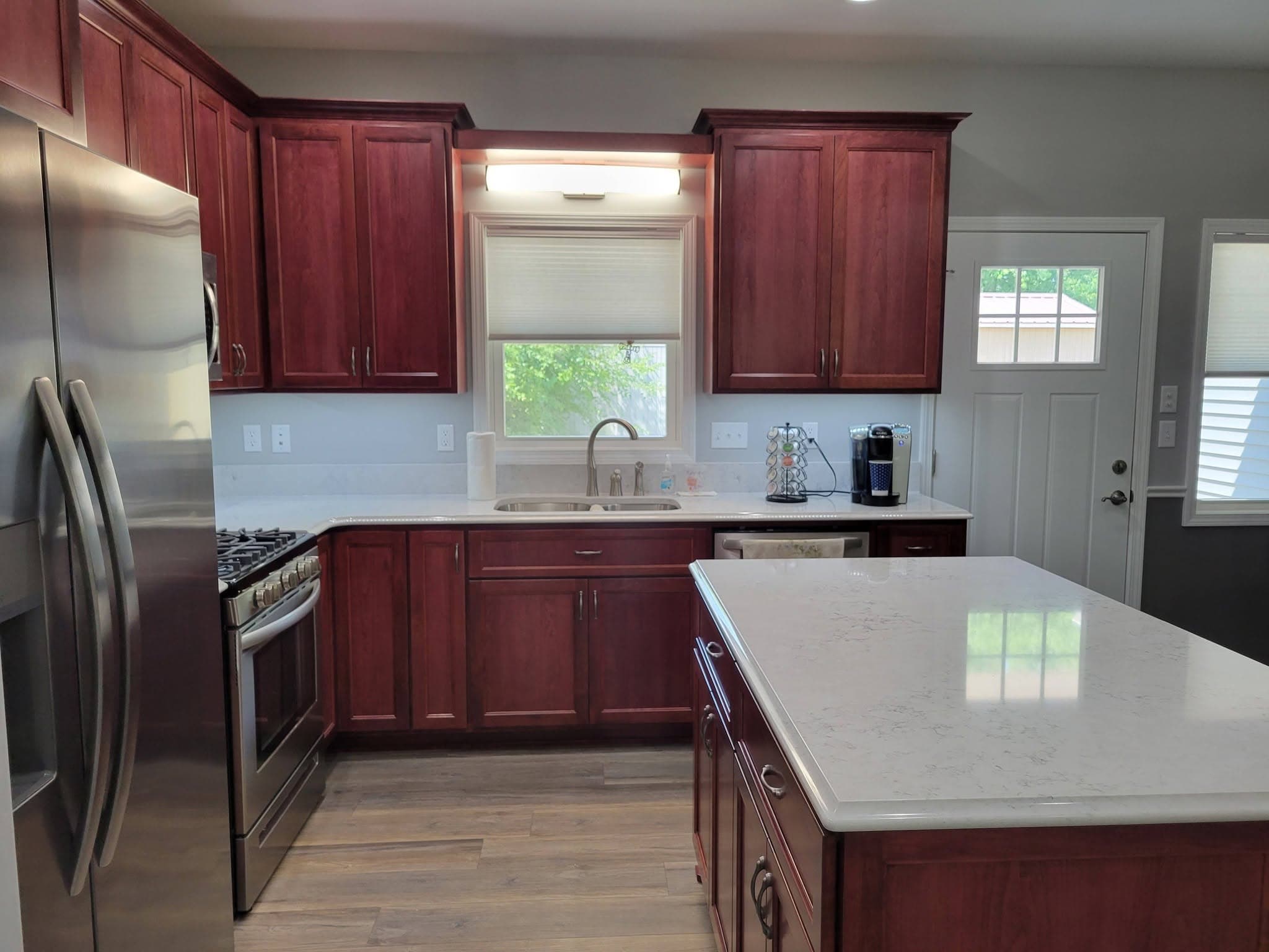 Cherry kitchen cabinetry with quartz-topped island