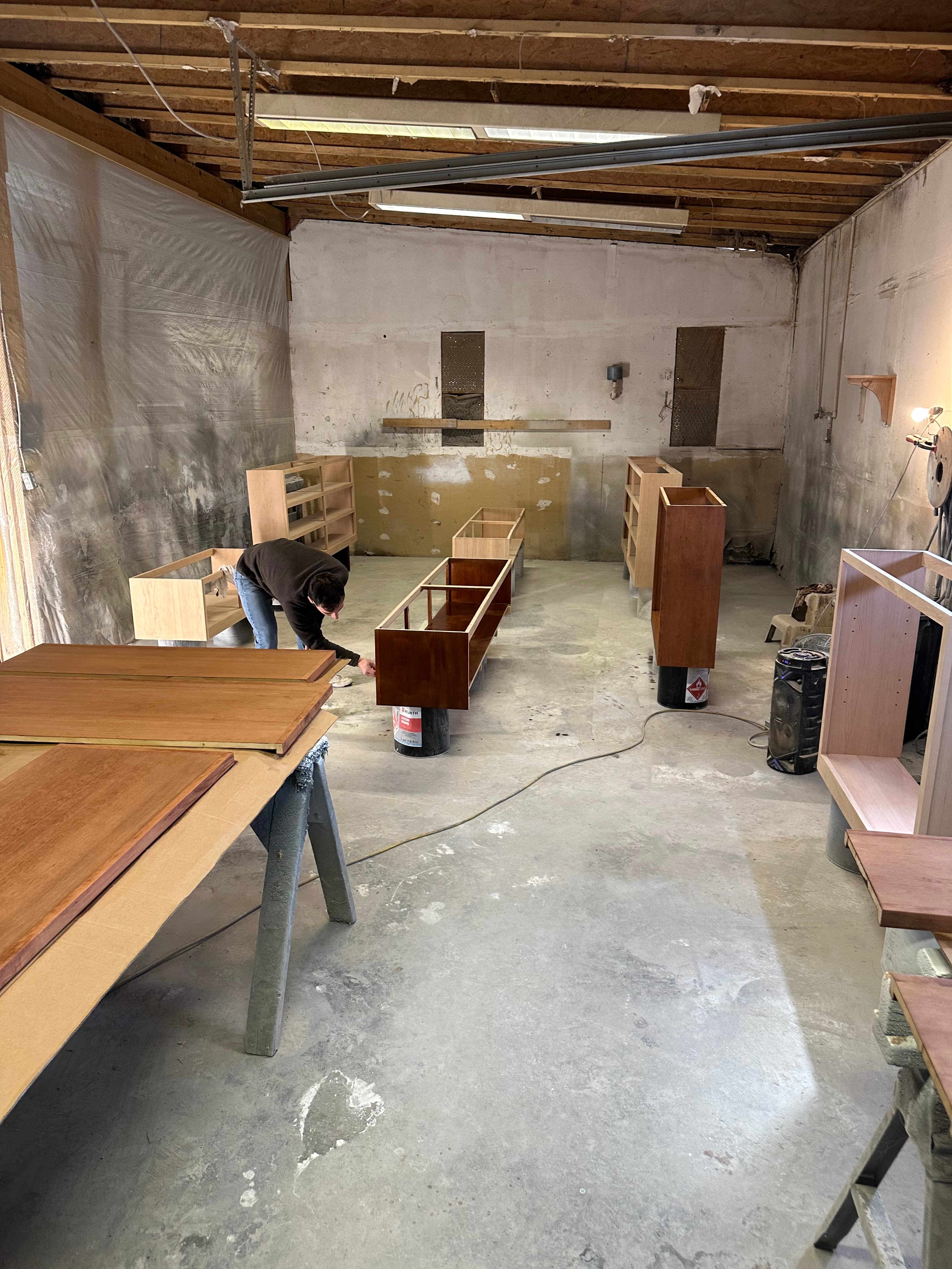 Custom cabinet components and woodworking projects arranged inside the cabinetry workshop
