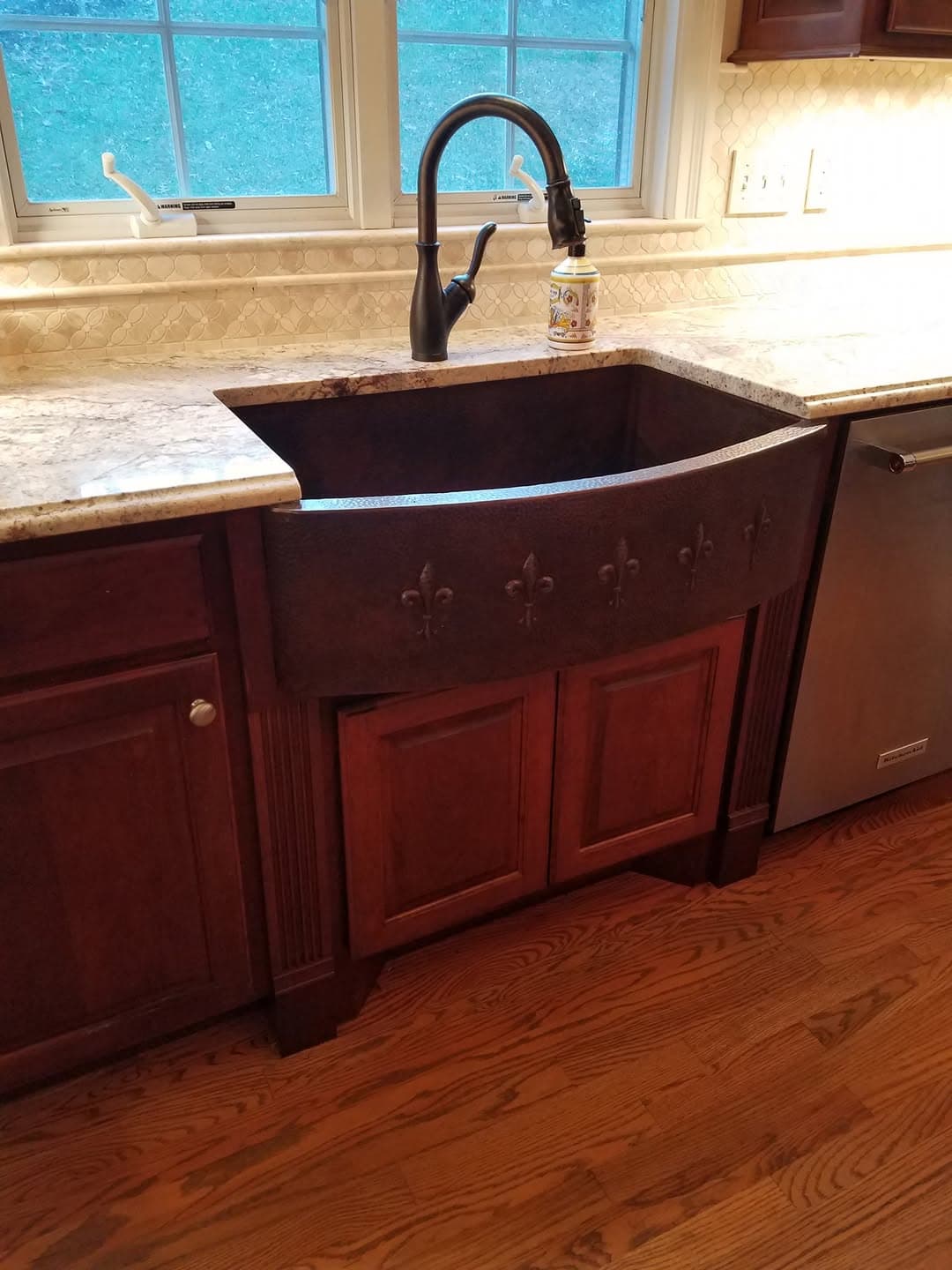 Custom cherry kitchen island and surrounding cabinetry
