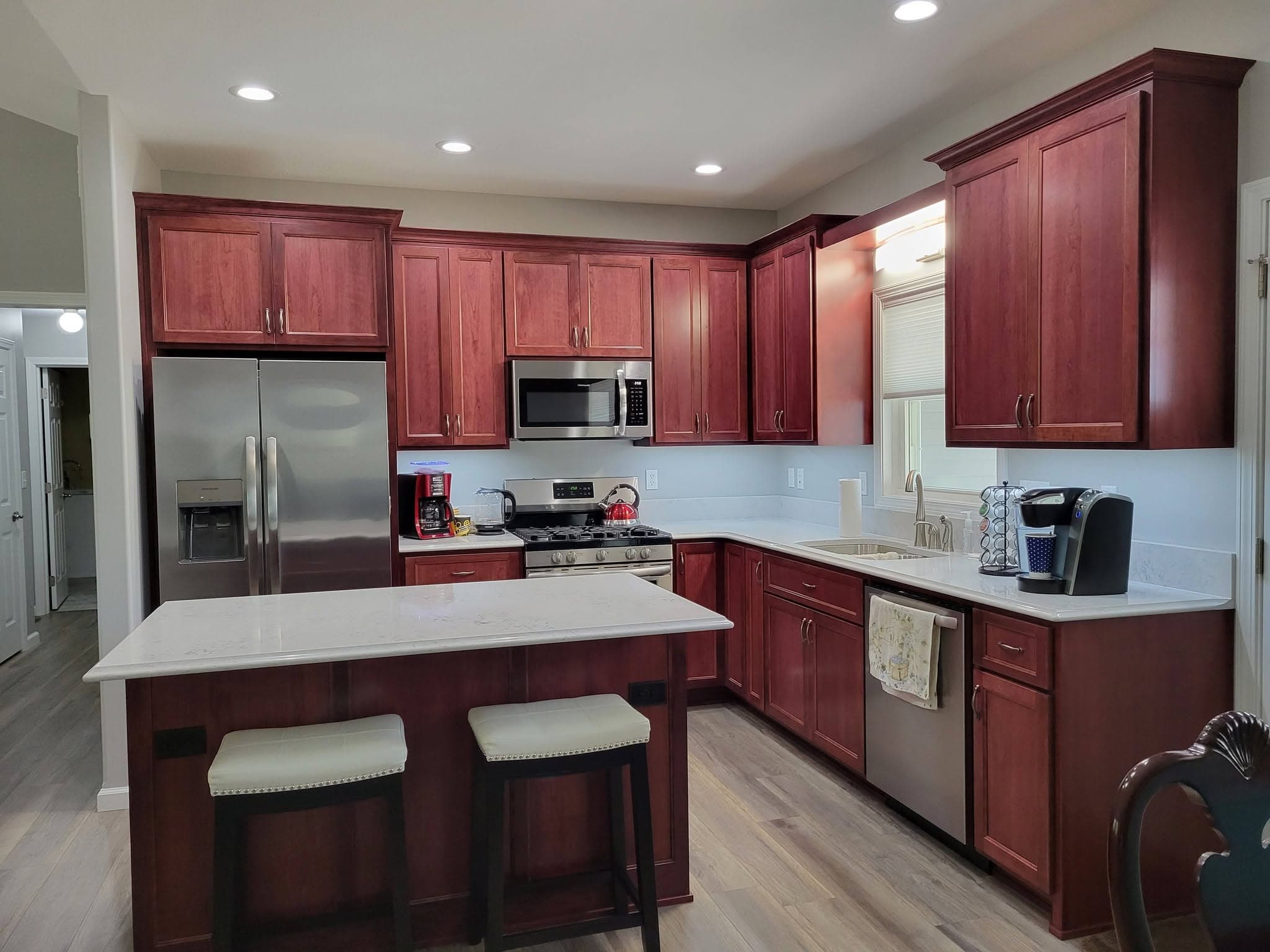Cherry kitchen with seating island and stainless appliances