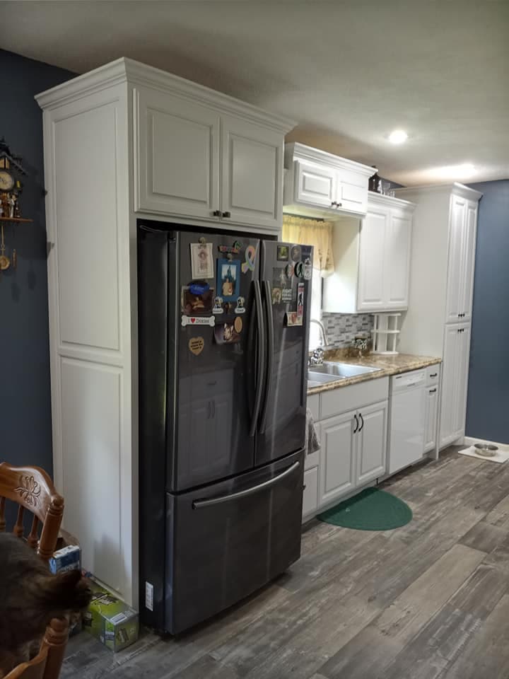 Custom kitchen refrigerator surround and pantry cabinetry
