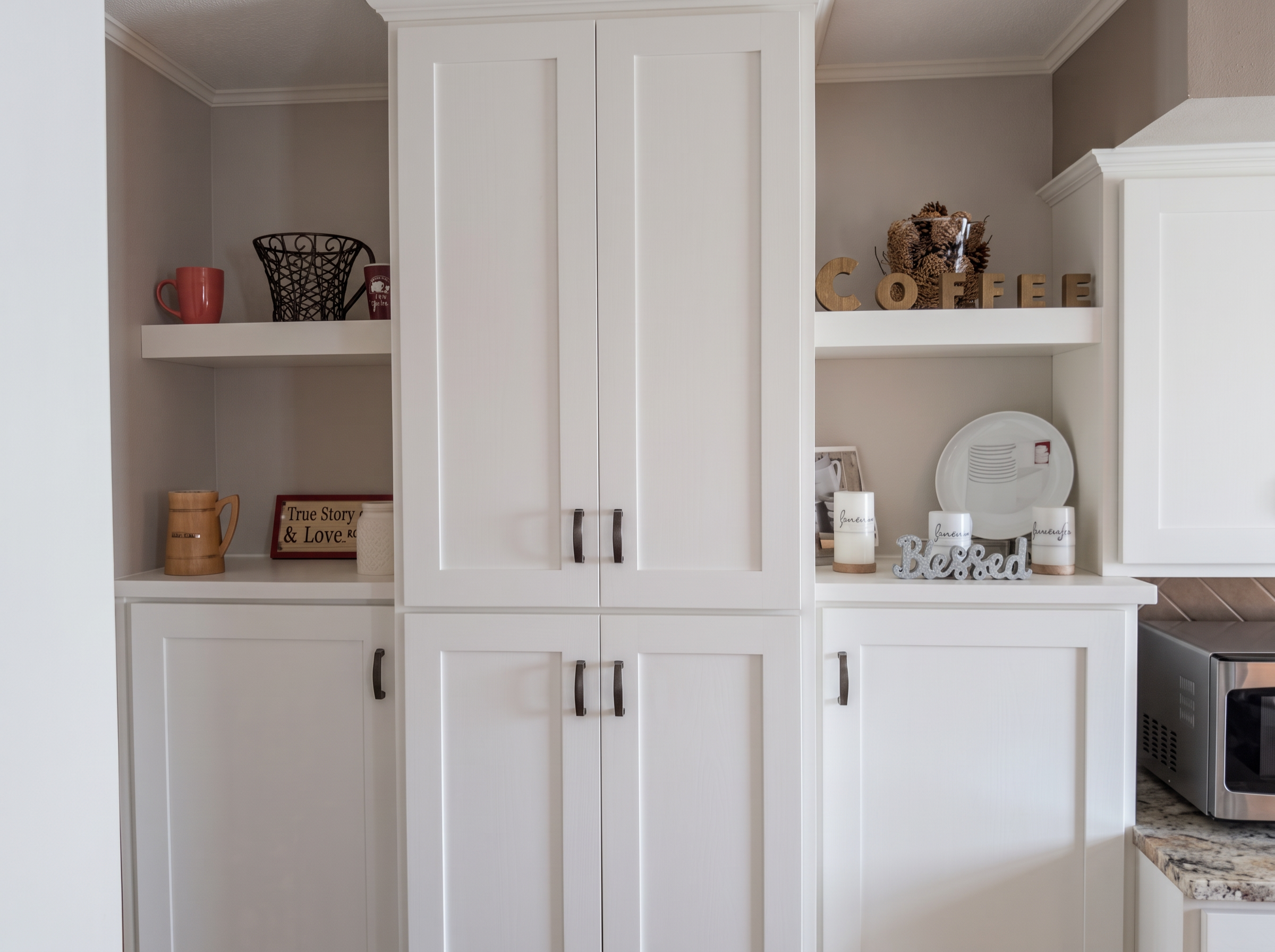 White pantry and tall cabinets with open display shelving