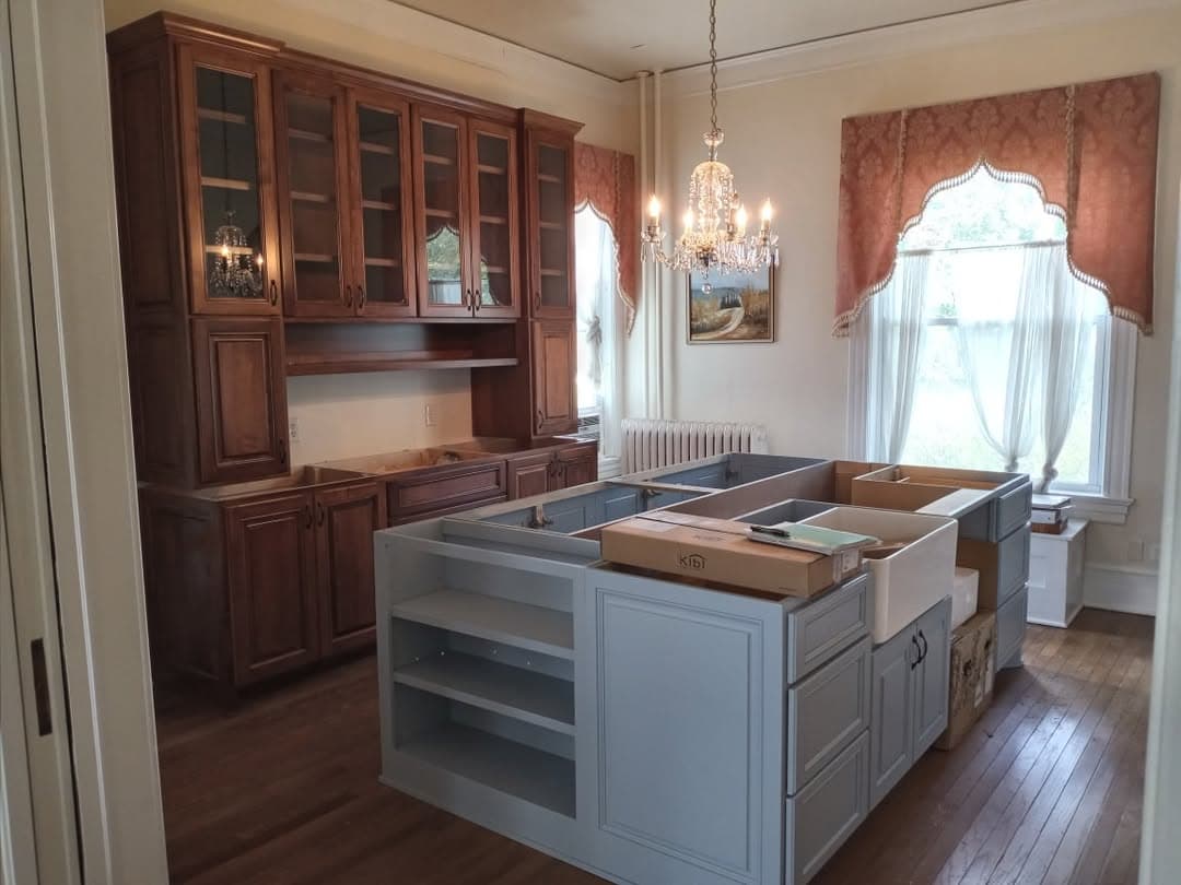 Custom cabinetry installation with a warm wood island and coordinated storage