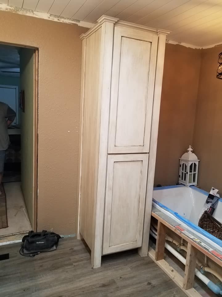 Custom unfinished tall pantry cabinet during installation