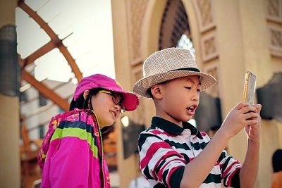 Two young children using a smart phone