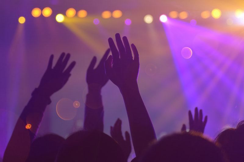 Hands raised in the audience of a live event