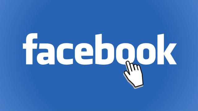 Hand cursor clicking on Facebook logo