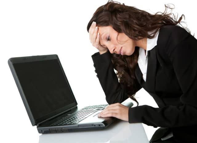 Female businessperson frustrated that her computer won't turn on