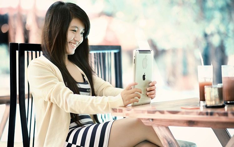 Girl smiling using an iPad