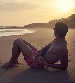 Shirtless man posing on the beach