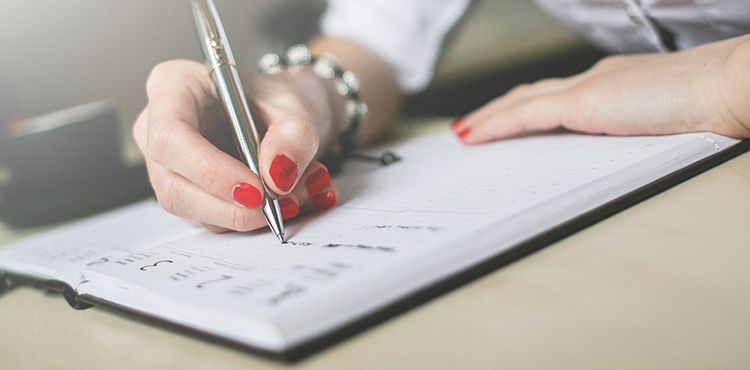 Photo of someone writing in their journal
