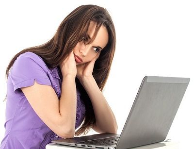 Frustrated woman in front of a laptop