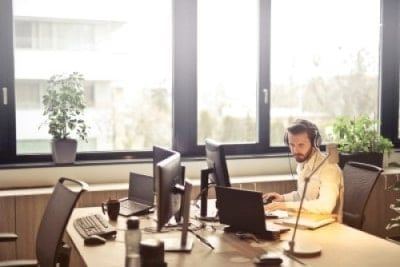 Man at computer with headset