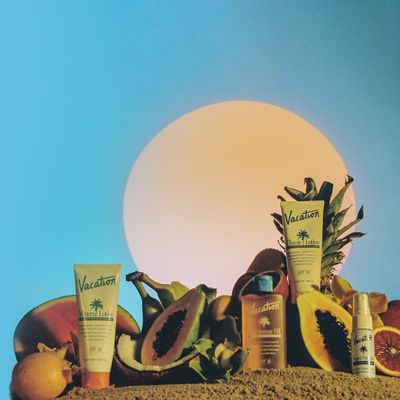 a group of sunscreens sitting on top of a pile of fruit .