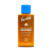 Vacation Chardonnay Oil SPF 30 sunscreen in an amber bottle with a blue cap