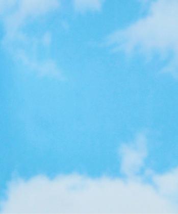 Light blue sky with soft white clouds