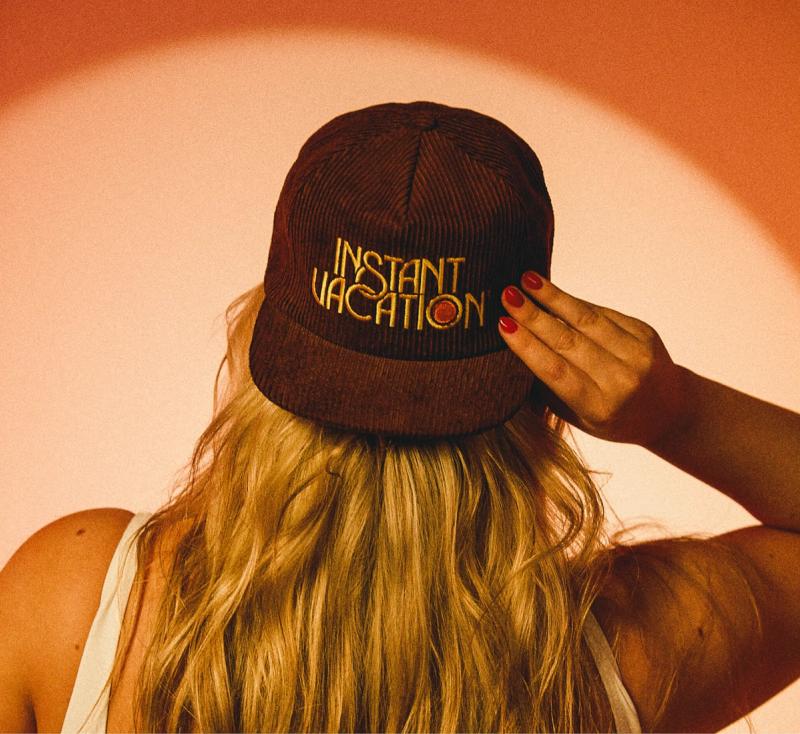 the back of a woman's head wearing an Instant Vacation® Corduroy Hat