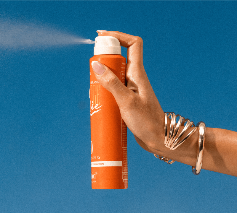 a woman spraying Orange Gelée Spray Oil