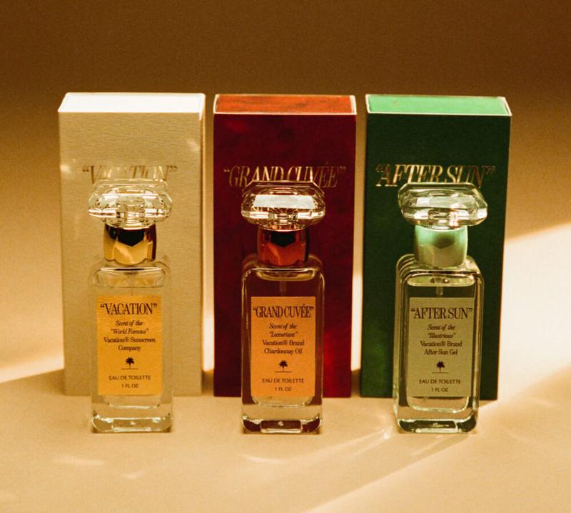 three bottles of perfume are sitting next to each other