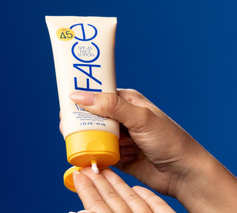 A hand squeezes Classic Face Lotion onto its fingers