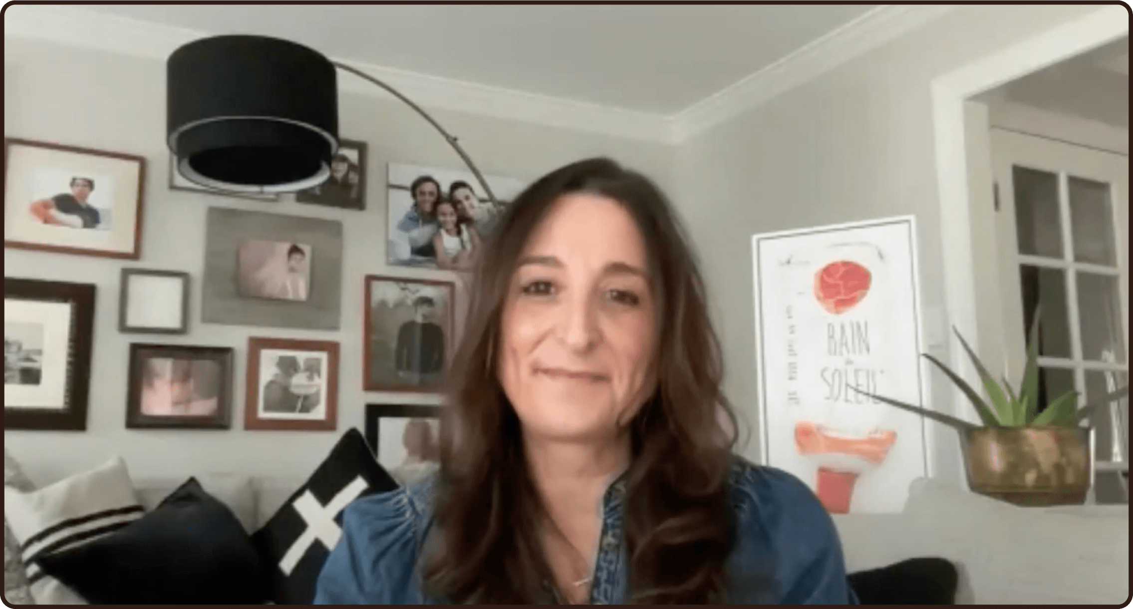 a woman sitting in front of a wall with pictures and a sign that says brain speed