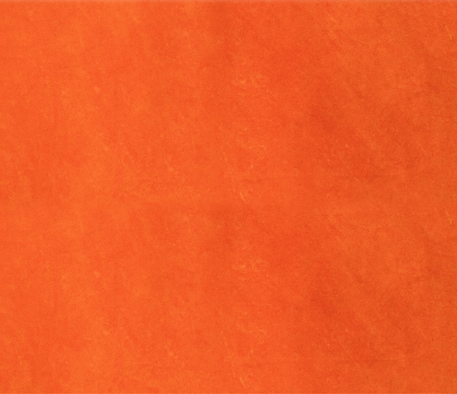 a close up of a piece of orange paper .