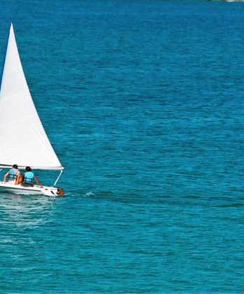 two people on a sailboat in the ocean