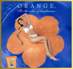 Woman in a white bikini lies on an orange flower float in blue water. Text: "ORANGE. It's the color of daydreams." An orange "RAIN" tube is visible.