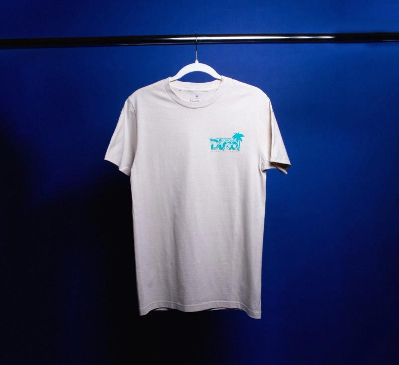 a Corporate Disco t-shirt is hanging on a hanger on a blue wall