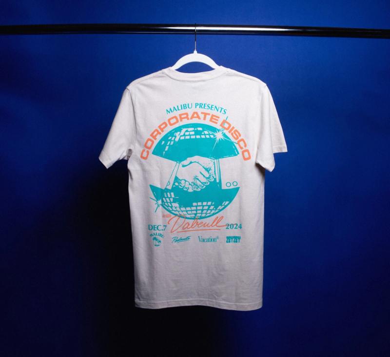 a Corporate Disco t-shirt is hanging on a hanger on a blue background