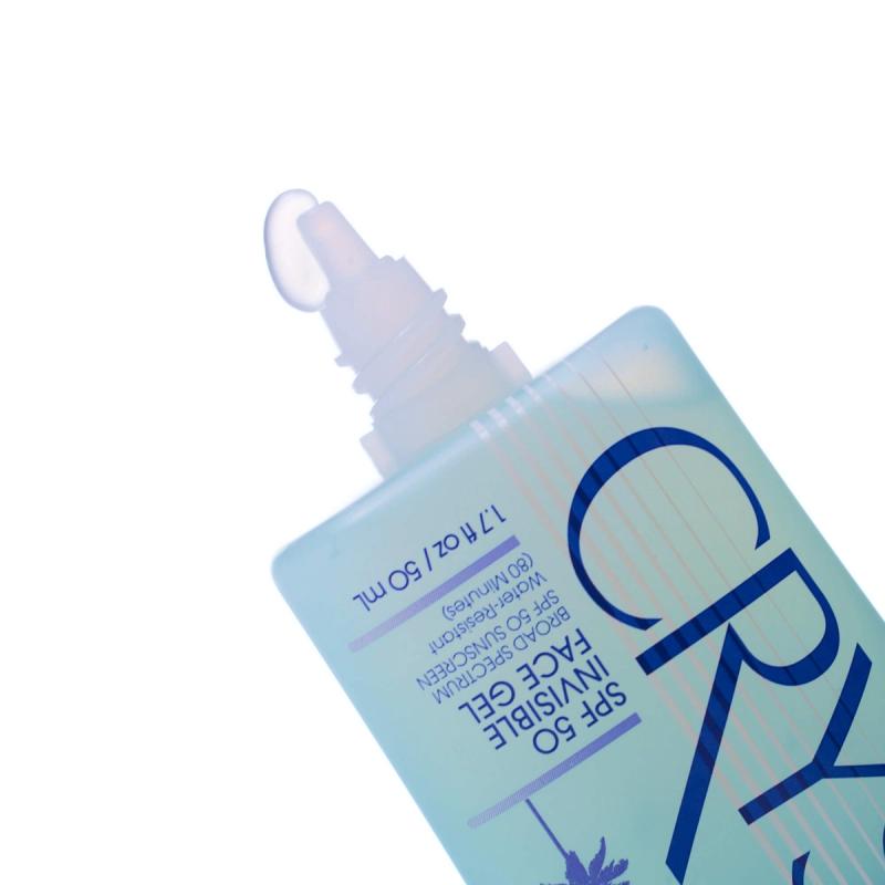 a bottle of Vacation® Crystal SPF 50 Invisible Face Gel with clear product coming out