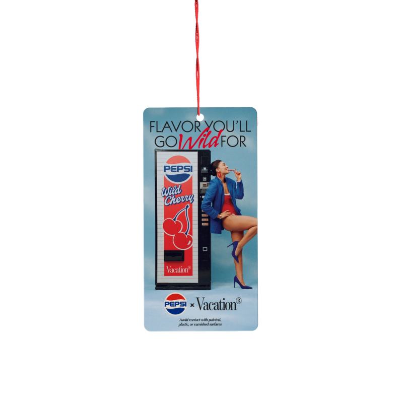 A promotional hang tag for Pepsi Wild Cherry and Vacation, featuring a vending machine, a woman in a swimsuit and blazer holding a cherry, and text 'FLAVOR YOU’LL GO Wild FOR'.