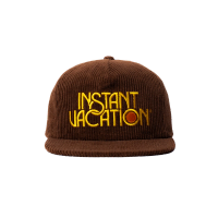 a brown hat that says instant vacation on it