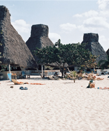 a beach with straw huts