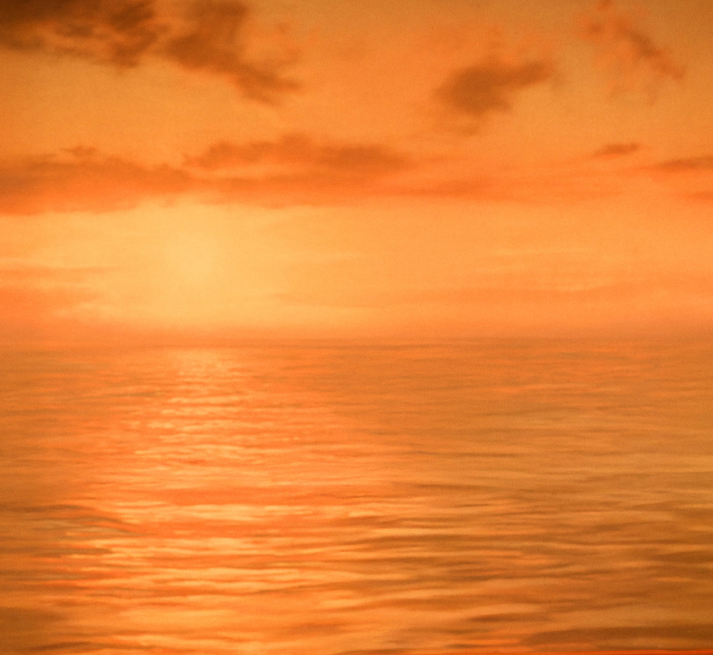 a sunset over the ocean with the sun reflected in the water .