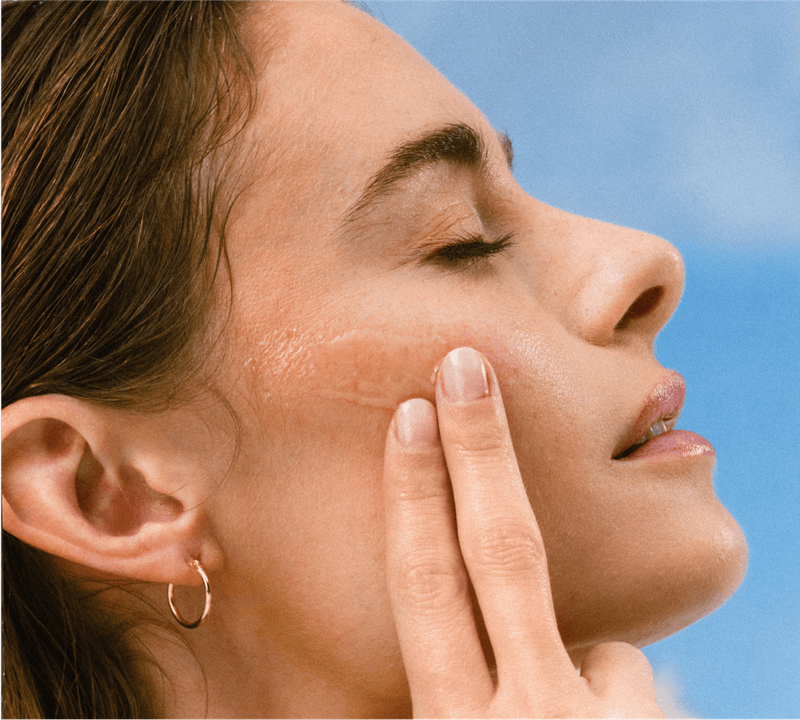 a close up of a woman's face applying the invisible Crystal Gel