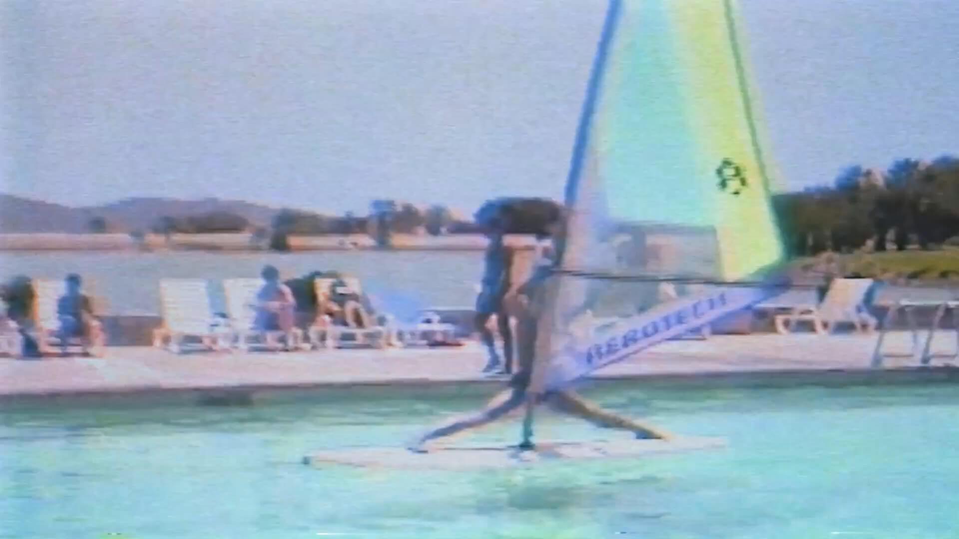 a man in a pool windsurfing