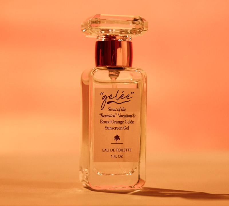 Clear perfume bottle labeled 'gelée' Scent of the 'Revisited' Vacation Sunscreen Gel Eau de Toilette, against an orange gradient background.