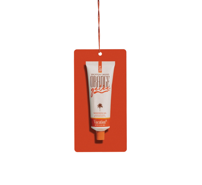 A white tube of Vacation Brand Orange Gelée Sunscreen Gel with an orange cap hangs from a red tag.