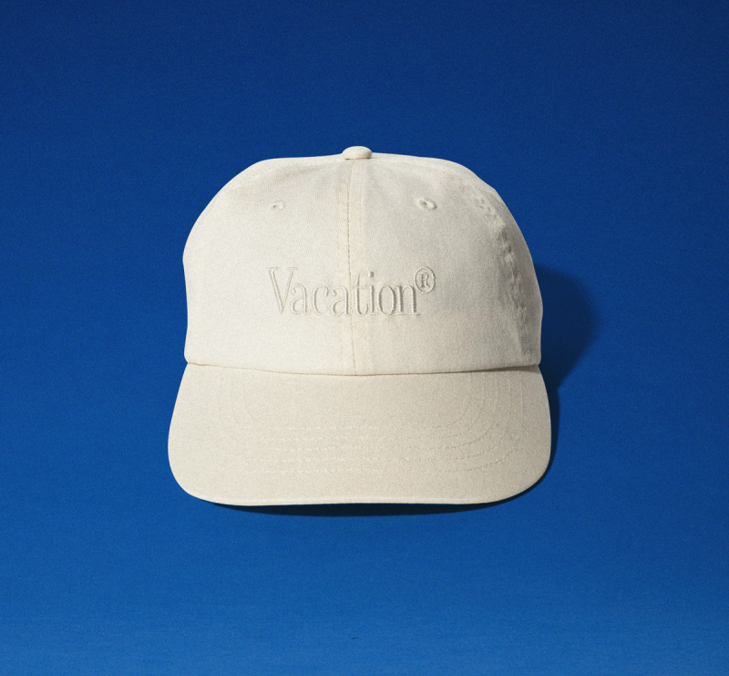 a white baseball cap with the word vacation embroidered on it