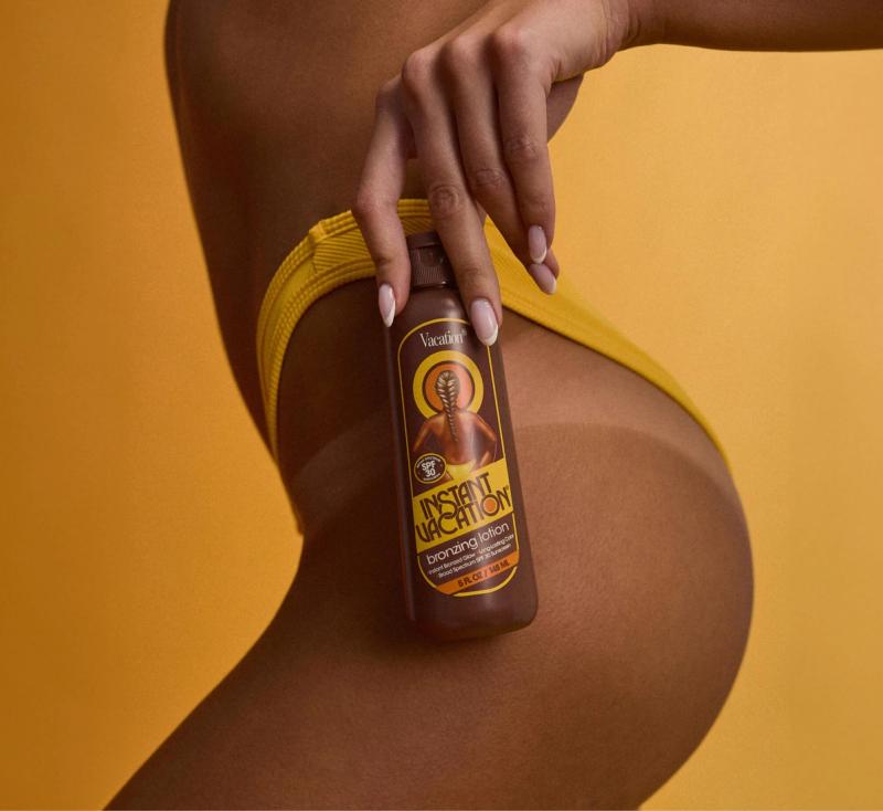 a woman in a bikini is holding a bottle of instant vacation bronzing lotion