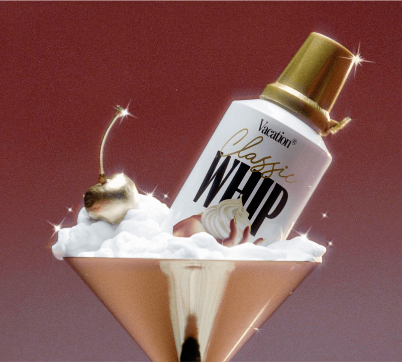 a bottle of vacation classic whip glow in a martini glass