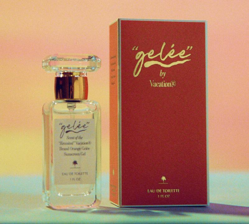 A clear bottle of "gelée" by Vacation® Eau de Toilette sits next to its orange box against a soft sunset background