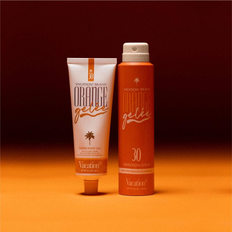 a tube of Orange Gelée® sits next to Orange Gelée® SPF 30 Spray Oil on an orange background