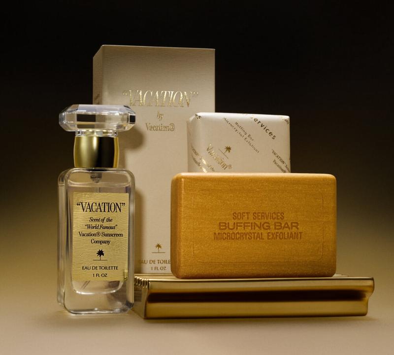 "VACATION" Eau de Toilette with its packaging near a gold Buffing Bar on a Soap Home