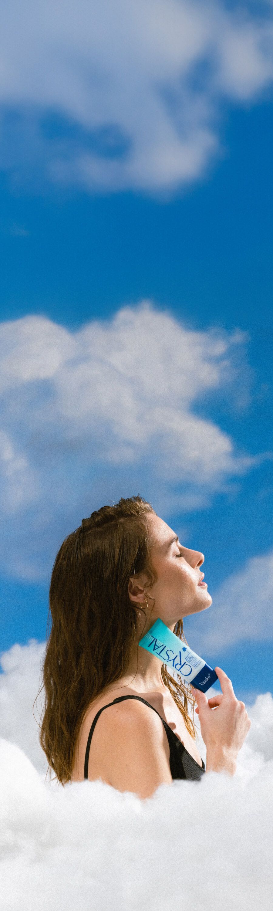 a woman is standing in the clouds holding a bottle of crystal gel
