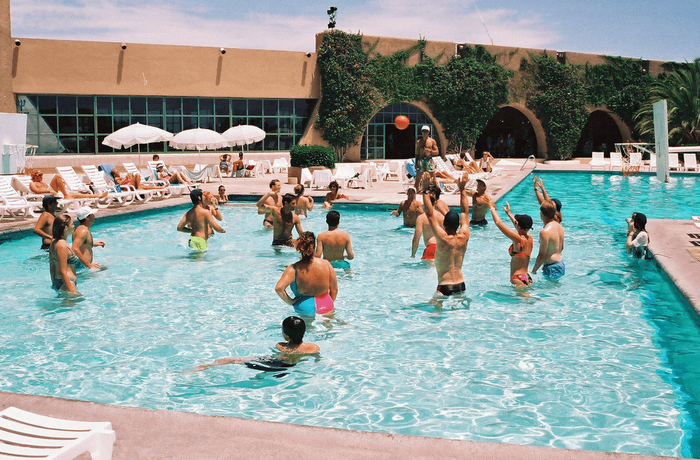 a group of people are playing in a swimming pool