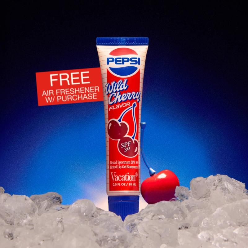 Pepsi Wild Cherry SPF 30 lip gel and a red cherry on ice, with a 'FREE AIR FRESHENER W/ PURCHASE' sign against a blue background.